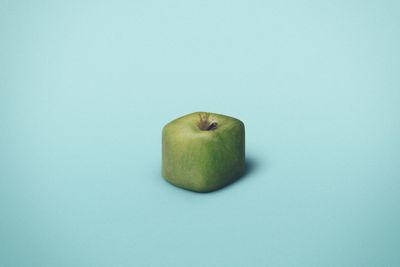 Close-up of apple over blue background