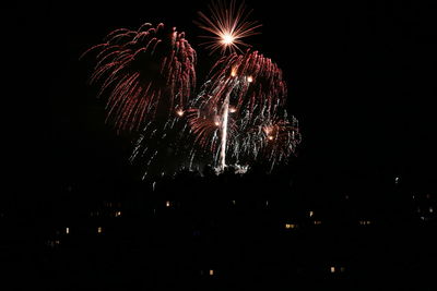 Low angle view of firework display at night