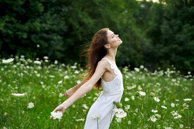 Side view of woman standing on field