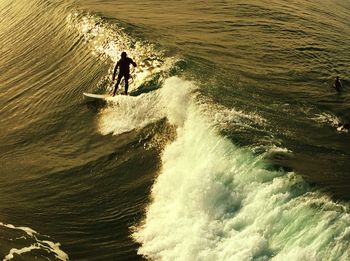 High angle view of man surfing in sea wave