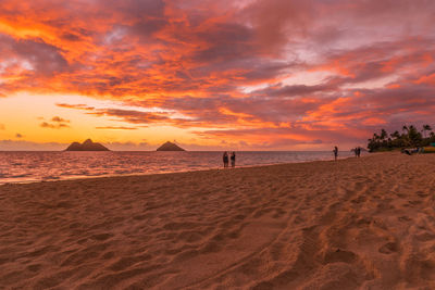 Scenic view of beach against sky during sunset