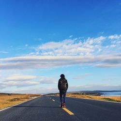 Rear view of man standing on road