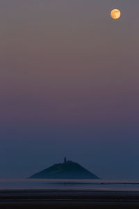 Scenic view of mountain against sky at sunset