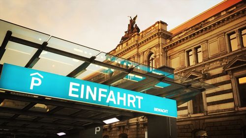 Low angle view of information sign against building