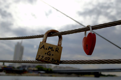 Close-up of padlocks hanging on rope