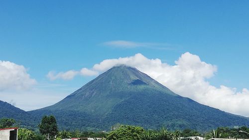 Scenic view of mountains against blue sky