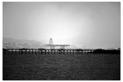 Pier over sea against clear sky