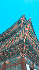 Low angle view of roof of building against blue sky