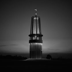 Low angle view of illuminated tower against sky at night