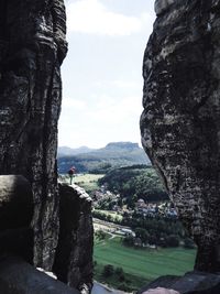 Man standing on cliff against sky