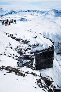 High angle view of people on snowcapped mountain during winter