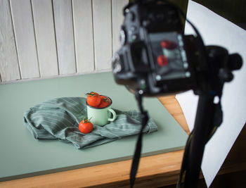 High angle view of tomatoes and mug on table