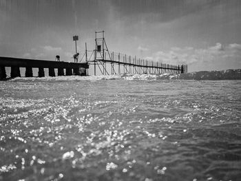 Bridge over sea against sky