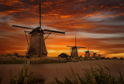 Old windmills in kinderdijk at dramatic sunset, netherland