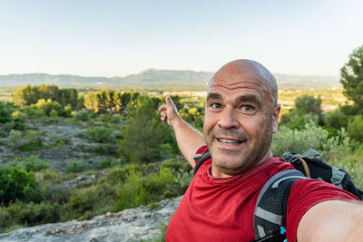 Hiker man take a selfie in the nature.