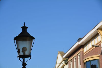 Low angle view of built structure against clear blue sky