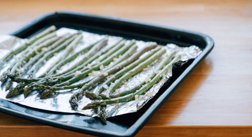 Green asparagus sprouts on frying pen in kitchen. grilled fresh vegetables