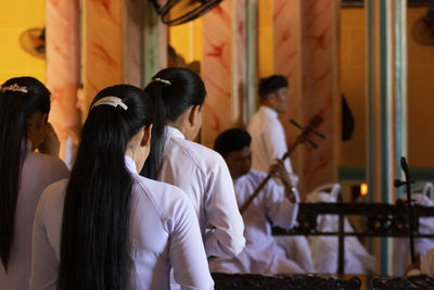 Close up of women during funeral celebration in cao dai temple