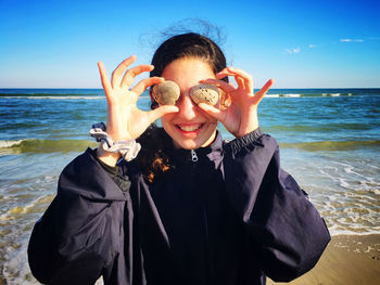Portrait of smiling young woman on beach