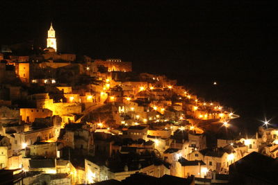 High angle view of illuminated buildings against sky at night