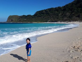 Full length of woman on beach against sky