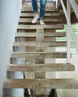 Low section of person standing on staircase