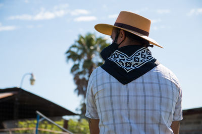 Rear view of man standing against sky