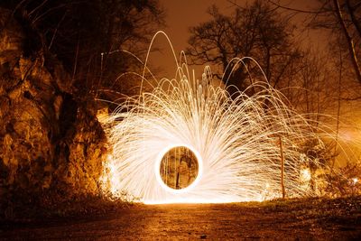 Blurred motion of illuminated lights on land at night