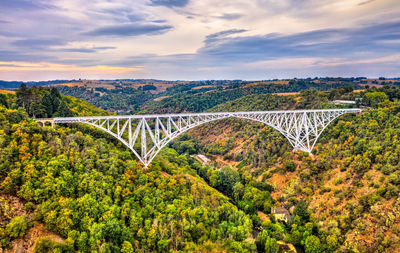 Arch bridge against sky during sunset