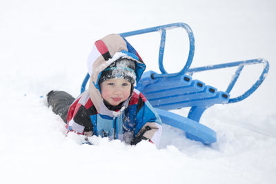 Portrait of boy playing on covered field