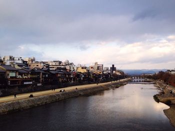 Buildings against cloudy sky