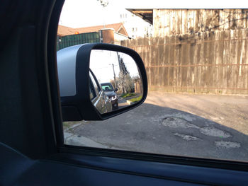 Reflection of car on side-view mirror