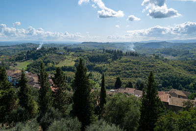 Panoramic view of trees and buildings against sky