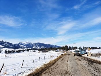 Scenic view of snowcapped mountains against blue sky