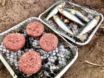 High angle view of meat on barbecue grill