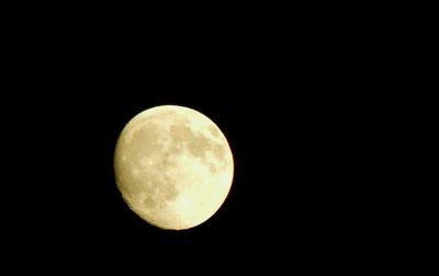 Low angle view of moon against clear sky at night