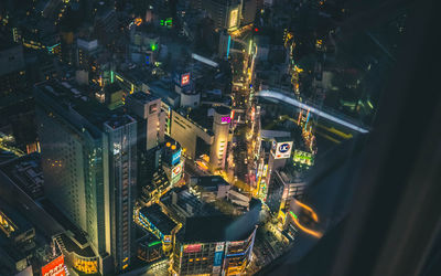 High angle view of illuminated buildings in city at night