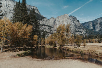 Scenic view of lake by trees against sky