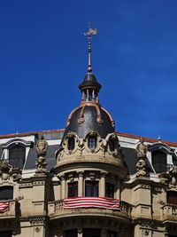 Low angle view of historic building against clear blue sky