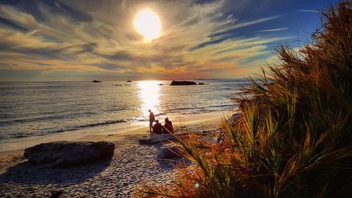 Scenic view of beach against sky during sunset