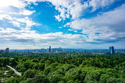 View of cityscape against cloudy sky