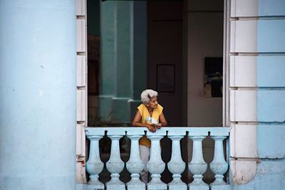 Portrait of woman standing against building