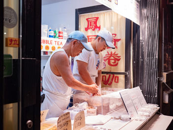 People working at market stall