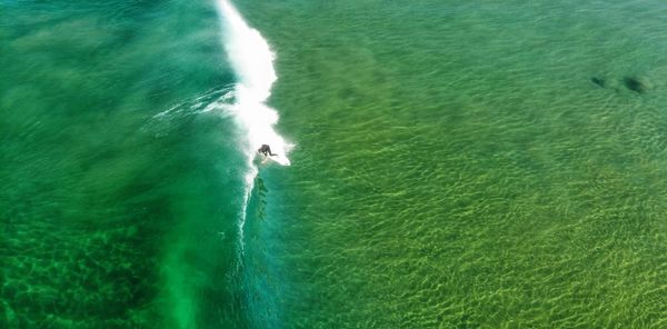 High angle view of man surfing in sea