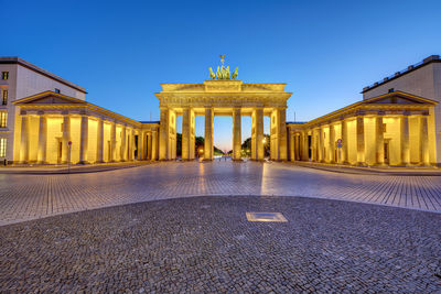 The illuminated brandenburg gate in berlin after sunset with no people