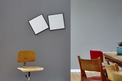 Empty chairs and table against wall at home