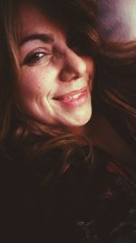 Close-up portrait of a smiling young woman