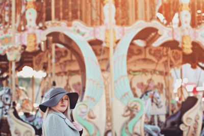 Close-up portrait of young woman in amusement park