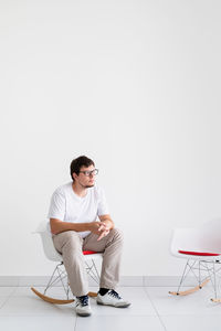 Mental health and healthcare. young depressed man with headache sitting on the chair