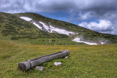 Scenic view of land and mountains against sky